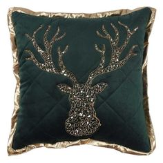 a green and gold pillow with a stag head on the front, surrounded by sequins