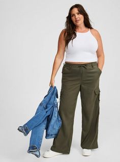 FIT Model is 5'11” wearing size 0. . Mid rise. . Inseam: 30”. . MATERIALS + CARE Drapey twill woven fabric. . 38% cotton, 59% tencel, 3% spandex. Machine wash cold. Line dry. Imported. DETAILS Elastic waistband with drawstring. . Side cargo pockets. . The best plus size women's pull-on weekend wide leg cargo pant pants in deep depths made of twill. Rock your look from Torrid to Festivals like Coachella and Lollapalooza, a concert, a show, or just for fun! Torrid is your destination for cozy fall Cargo Pant, Bottom Clothes, Cozy Fall, Bottoms Pants, Woven Fabric, Mid Rise, Winter Outfits, Fitness Models, Wide Leg