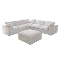 a white sectional couch with ottoman and footstool in front of a white background