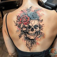 a woman with a skull and roses tattoo on her back