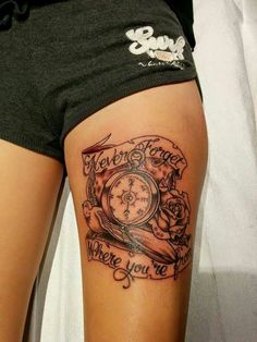 a woman's thigh with a clock and roses on it