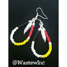 two pairs of beaded earrings with feathers on them