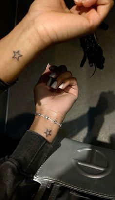 a woman with a small star tattoo on her wrist