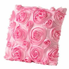 a pillow made out of pink roses on a white background