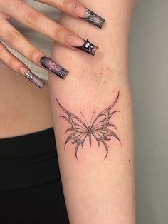 a woman's arm with a butterfly tattoo on the left side of her body