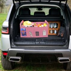 the back end of a car with its trunk open and food in it's cargo compartment