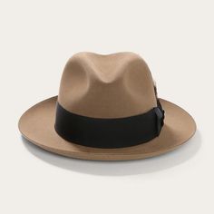 A nod to the 1940s jazz bars of New York City. An icon in its own right, the Temple is a statement of distinctive style. Made from quality felt, it features a center pinch front crown and a wide grosgrain ribbon hat band nicely offset by a bold feather accent. On the interior, a roan leather sweatband and satin lining Indiana Jones Films, Popular Dress, Jazz Bar, Stetson Hat, Wide Trousers, Vintage Silhouette, Thigh Boot, Vintage Hats