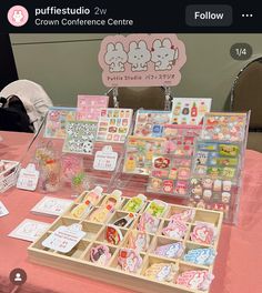 the table has many different items on it for sale at this event, including cards and magnets