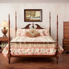 a large bed sitting on top of a wooden floor next to two nightstands and a lamp