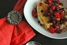 a white bowl filled with food next to a red napkin on top of a table