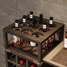 a wooden shelf with bottles on top of it next to a box of whiskeys