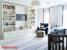 a living room filled with furniture and a baby crib