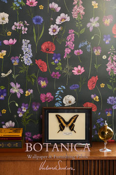 the wallpaper is decorated with colorful flowers and a butterfly on it's wings