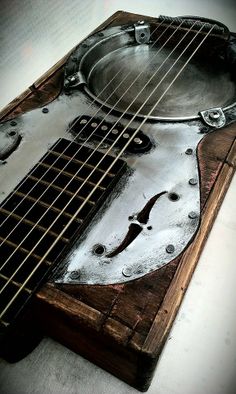 an acoustic guitar is made out of wood and metal