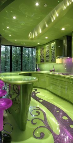 a green kitchen with purple stools next to the counter top and an oval shaped table