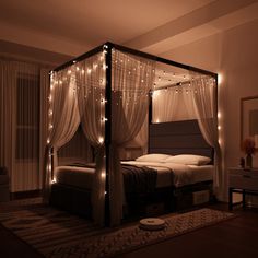 a canopy bed with lights on it in a bedroom