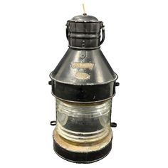 an old metal lantern with a candle on it's side and a white background