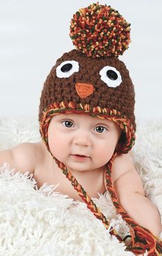 "I hand crocheted this Thanksgiving turkey hat to fit babies, toddler girls and boys, kids, & women. This chunky knit beanie is a wonderful photography prop for Fall and Autumn newborn photo shoots. It's a darling baby shower gift, cute hospital hat, and festive accessory family pictures, holiday cards, and parties. It features earflaps, braided tails, a giant pom pom, eyes with buttons, and an embroidered beak. The fluffy pom pom is 12\" around (the size of a softball). SIZES: Newborn: 12 t Fall Newborn Photos, Giant Pom Pom, Thanksgiving Photo Props, Baby Pom Pom Hat, Baby Thanksgiving, Autumn Newborn, Thanksgiving Hat, Baby Turkey, Turkey Hat