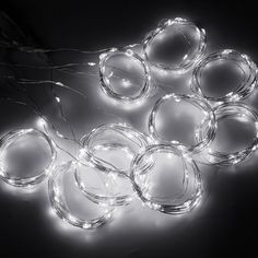 white leds are arranged on the floor in circles with wires attached to them and plugged into each other