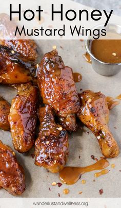 honey mustard glazed chicken wings with sauce on the side and text overlay that reads, hot honey mustard roasted wings