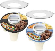 three trays with food on them and one has a lid that holds two plates