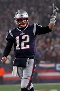 a football player holding his hand up in the air