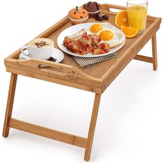 a wooden tray with breakfast food on it