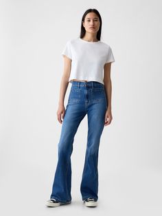 Fit: Snug & flattering through the hip & thigh with a flared leg. ​ Fabric: 86% Cotton, 13% Recycled Materials, 1% Stretch.  Stretch: Stretch Jeans.  A bit of hug & a lot of hold.  Comfortable & designed to flatter.  Rise: High Rise Jeans.  Look: A four-pocket jean in a medium indigo wash.  Details: Zip fly, front & back patch pockets.  Responsibly Made: This pair of jeans is part of our water-saving Washwell program.  Compared to conventional wash methods, Washwell has saved millions of liters Gap Flare Jeans, 70s Flare Jeans, Patch Pocket Jeans, Bar Clothes, Flare Jeans Outfit, 2024 Moodboard, Toddler Jeans, Water Saving, Gap Women