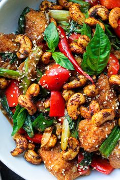 a white bowl filled with chicken and vegetables