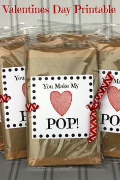 three bags filled with valentine's day printables on top of each other