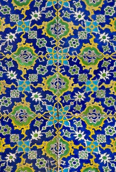 an intricate blue and green tile pattern on the side of a building in tunis, morocco