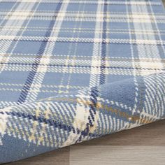 a blue and white plaid rug on the floor