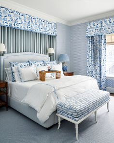 a bedroom with blue and white decor in it