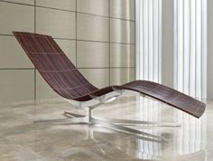 a lounge chair sitting on top of a tiled floor