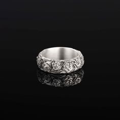 Silver Roses Band Ring: A Symbol of Everlasting Beauty Step into a world where elegance meets timeless charm with our Silver Roses Band Ring. This exquisite piece, beautifully handcrafted, captures the essence of the rose, a symbol of love, beauty, and the enduring nature of true affection. Perfect for those who appreciate the depth of nature's artistry and the romantic allure of roses, this ring is a testament to love's everlasting bloom. Key Features: Eternal Symbolism: The rose stands as a ti Silver Rose Ring, Rose A, Pattern Ring, Rose Ring, Love Symbols, Rose Pattern, Silver Roses, The Rose, Metal Rings