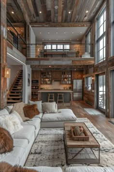 a living room filled with lots of furniture next to tall windows and wooden beams on the ceiling