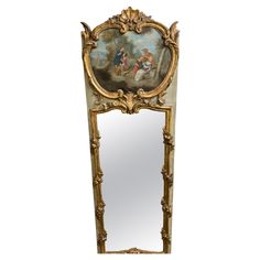 an ornate mirror with a painting on it