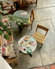 an overhead view of a table and chairs with food on it