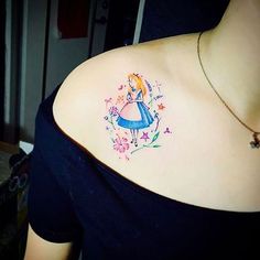 the back of a woman's shoulder with an image of a princess on it