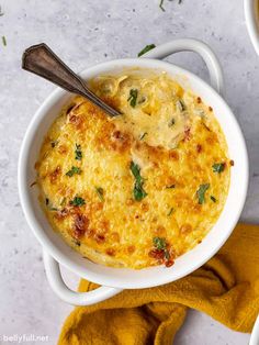 an overhead view of a casserole dish with cheese and herbs