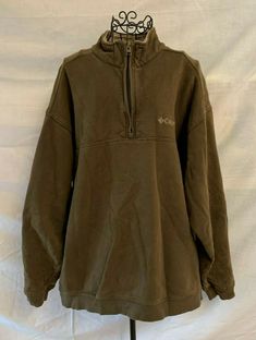 This pullover is in Good used condition.  It is made of 77% cotton and 23% polyester.  There is a collar with a 1/4 zip closure so you can wear your collar up.  The sleeves are long with a ribbed cuff.  There is also a ribbed trim on bottom of shirt.  The outside is a sweatshirt feel fabric and the inside is fleece.  The Columbia logo is on the left chest and on the back of neck. Chest- 49" Length- 28" Sleeve Length- 21.5" Clean smoke free home. AS128 Columbia Sweater Outfit, Columbia Sweater, Columbia Logo, Thrift Inspo, Columbia Sweaters, Green Pullover, Columbia Sportswear, Green Sweater, 1/4 Zip