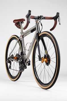 a silver and brown bike with wooden seatposts on it's front wheel