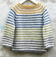 a striped sweater hanging on a hanger