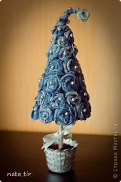 a small blue christmas tree sitting on top of a table