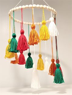 a mobile with tassels hanging from it