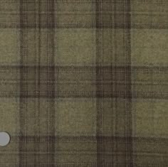 a brown and black plaid fabric with a white button on it's left side