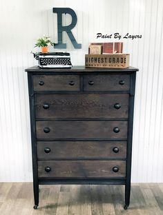 an old dresser has a typewriter on top