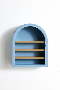 a blue wall mounted shelf with wooden shelves