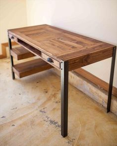 a wooden table sitting on top of a hard wood floor next to a white wall