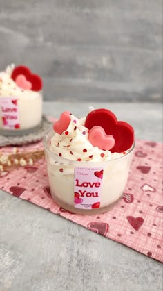 two small bowls filled with whipped cream and hearts